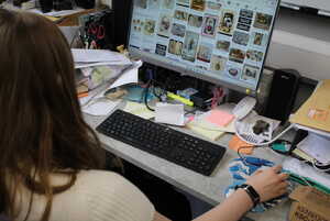 Finding photos for a Victorian Scrapbook a person working at a desktop computer