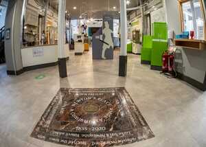 Interior of a modern space with a decorative floor and green accents.